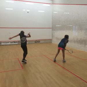 girls playing squash